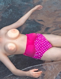 Redhead doll Misha Lowe extracts her hooters from her bikini