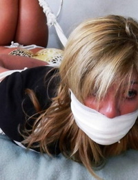 Light-haired girl is trussed up with rope and left gagged in undergarments and pumps