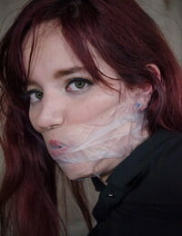 Tattooed gimp Ariel Blue in nylons tied spreadeagled and ball-gagged with gauze