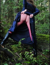 Mature woman Tasty Trixie heads into the woods to flash in a long velvet dress