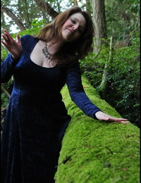 Mature woman Tasty Trixie heads into the woods to flash in a long velvet dress