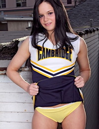 Teenager cheerleader Jenna Ross doffs her uniform to position bare on a rooftop patio