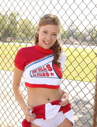 Teenage cheerleader Nicole Ray with a tongues face spreads her twat