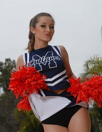 Teenage cheerleader Dani Daniels pulls up her micro-skirt to toy her gloryhole