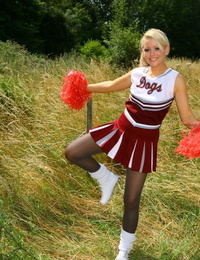 Beautiful European cheerleader Tamar poses in black tights in nature