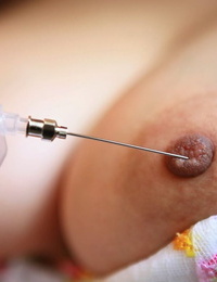 Fine Japanese nurse Namie Koshino pokes her nude assets parts with a needle