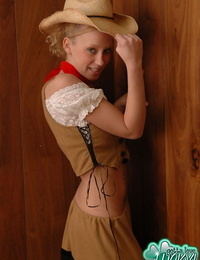 Cute blond girl with blue eyes flashes her bare ass in cowgirl apparel
