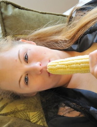 Scorching redhead chick takes off nude on the street and toys with banana and corn cob