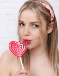 Young looking teen Daria gets bare while big-chested on a lollipop