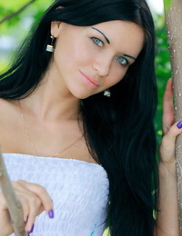 Constant Russian teen Kitti A undresses fully bare under a tree