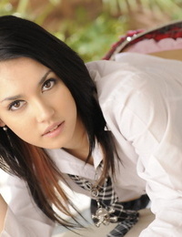 Japanese teen Maria Ozawa holds her pretty face firm in her schoolgirl clothes