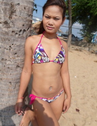 Tasty teenager Thai honeys Bee and Miaw posing at the beach in hot bathing suits