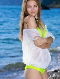 Teen babe Izabel A sporting nice camel toe outdoors on beach in bikini