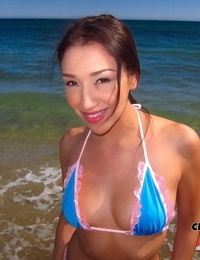 Amateur asian accomplished Vicki Pursue posing on the beach in a bathing suit