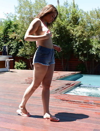 Leggy teen babe Kylie Quinn strips off shorts and bikini outdoors by pool