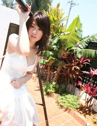 Stunning asian stunner with adorable knockers Risa Misaki unclothing by the pool