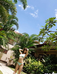 Cute asian honey Hikari Hino slipping off her bathing suit top outdoor
