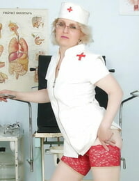Saucy mature nurse in glasses displaying her knockers and drenching moist beaver