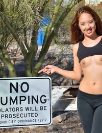 Fit teen lady stops to fist her photos while out for a morning jog