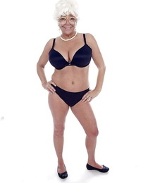 Granny pornstar Karen Summer modelling fully clothed before stripping nude