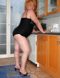 Fatty granny on high high-heeled shoes spreading her arse to show her taut slots