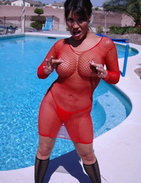 Latina American female Ava Devine rips open her mesh dress beside the pool