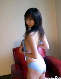 Seductive asian babe with neat fanny leisurely gliding off her clothes
