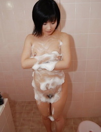 Asian doxy Minori Nagakawa taking shower and teasing her bushy twat