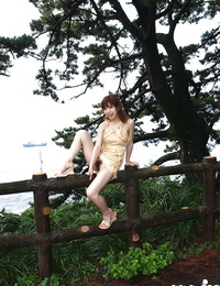 Nasty asian cutie An Nanba slipping off her dress outdoor