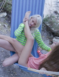 European teenagers Nika N and Milena D seize pussy atop a hammock as sun falls