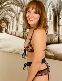30 plus redhead Cyndi Sinclair doffs 3 piece lingerie and nylons to pose nude