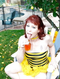 Outdoor close up posing of an mature slut with red short hair