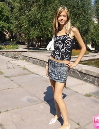 Youthful thin girl in short skirt removes her panties to walk in the sunshine