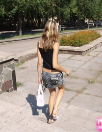 Youthful thin girl in short skirt removes her panties to walk in the sunshine