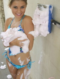 Dressed fledgling Jannah Burnham gets covered in suds at the local car wash