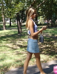 Cute young blond in denim short skirt showcasing off her sexy pierced belly button