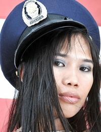 Stunning amateur Asian Anne poses in the impressive police uniform