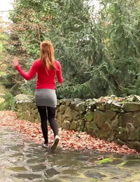 Redhead Sandra lifts her micro-skirt to take a long hot urinate in public