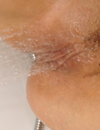 Cute blonde teen pleases her horny pussy with stream of water from showerhead