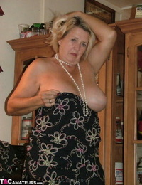 Big grandmother with blonde hair exposes herself in sunburn nylons and garters