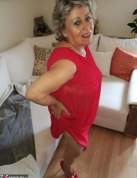 Horny oma Caro hikes up long red dress to opened up her fur covered vagina