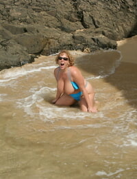 Thick titted mature amateur Curvaceous Claire gets down on all fours on a beach as she surf washes in