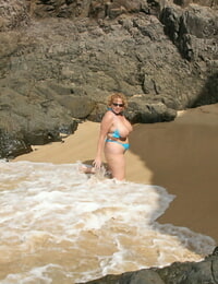 Thick titted mature amateur Curvaceous Claire gets down on all fours on a beach as she surf washes in