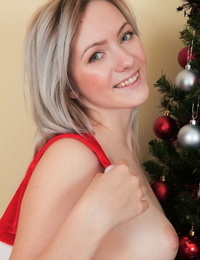 Teen very first timer Lulya thumbs her clean-shaved vagina in front of the Christmas tree