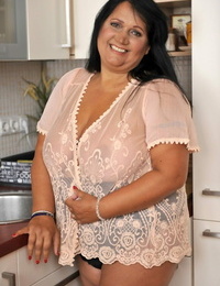 BBW brown-haired Bubi poses and demonstrates her big innate boobs in a kitchen
